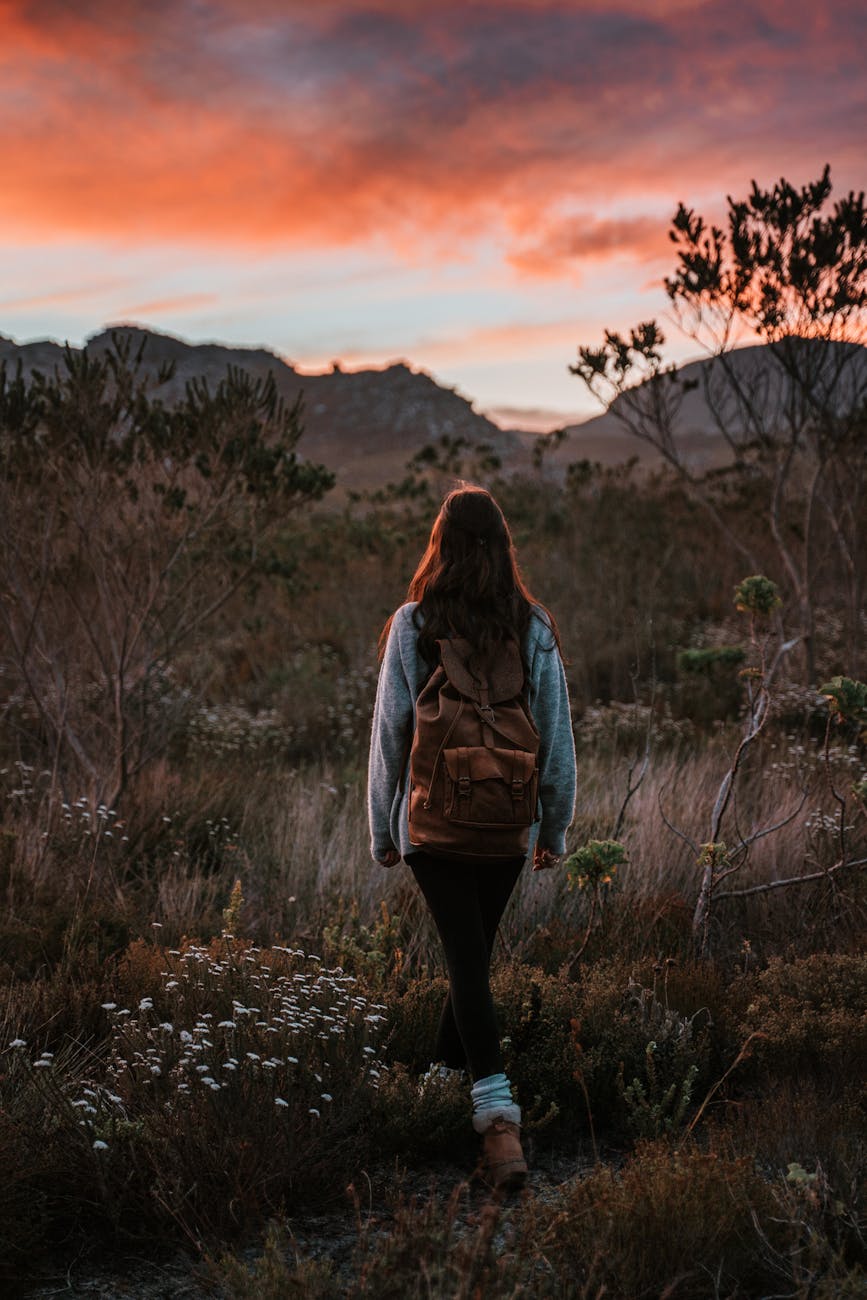 Solo female traveler walking in a field